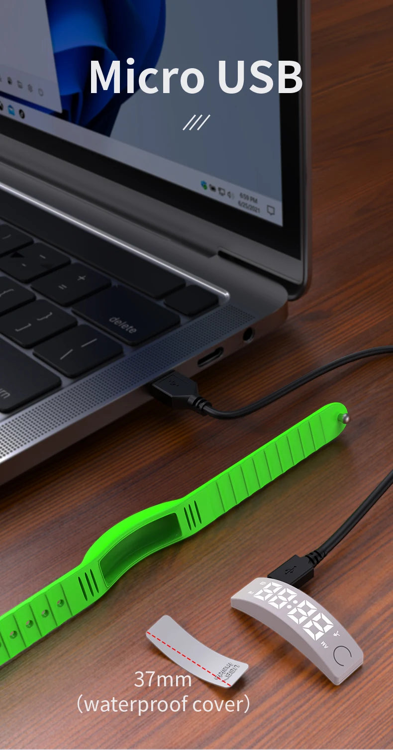 NOVIQ Wake wristband charging by Micro USB from a laptop, showing the 37mm module with waterproof cover removed from the strap